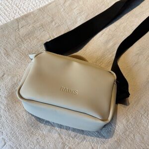Rains cream crossbody bag with black strap